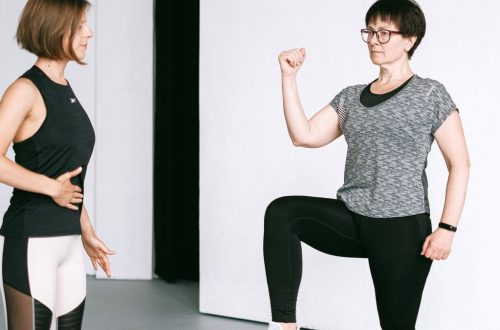 Two women working out together, demonstrating fitness exercises on a white background.